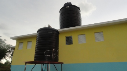 Both tanks installed! The top is for potable water and is filled using a solar powered pump from a water supply 1,000 feet away. The bottom collects rainwater from the roof. Both use gravity for water pressure.